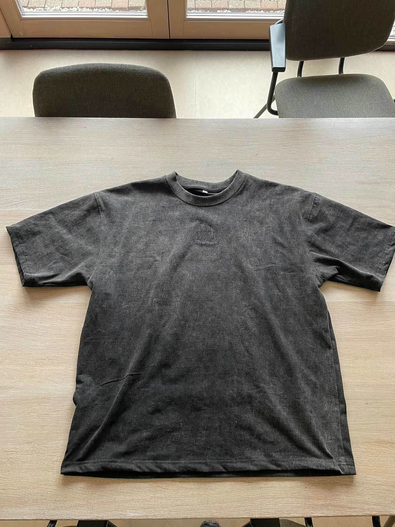 A raw phone photo of a garment before VISUAILS